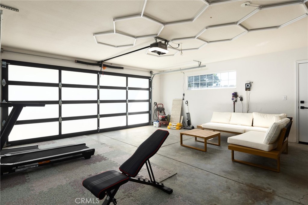 341 North 4th Street Grover Beach, CA 93433 - Photo 22 of 33 a living room with furniture gym equipment and a large window