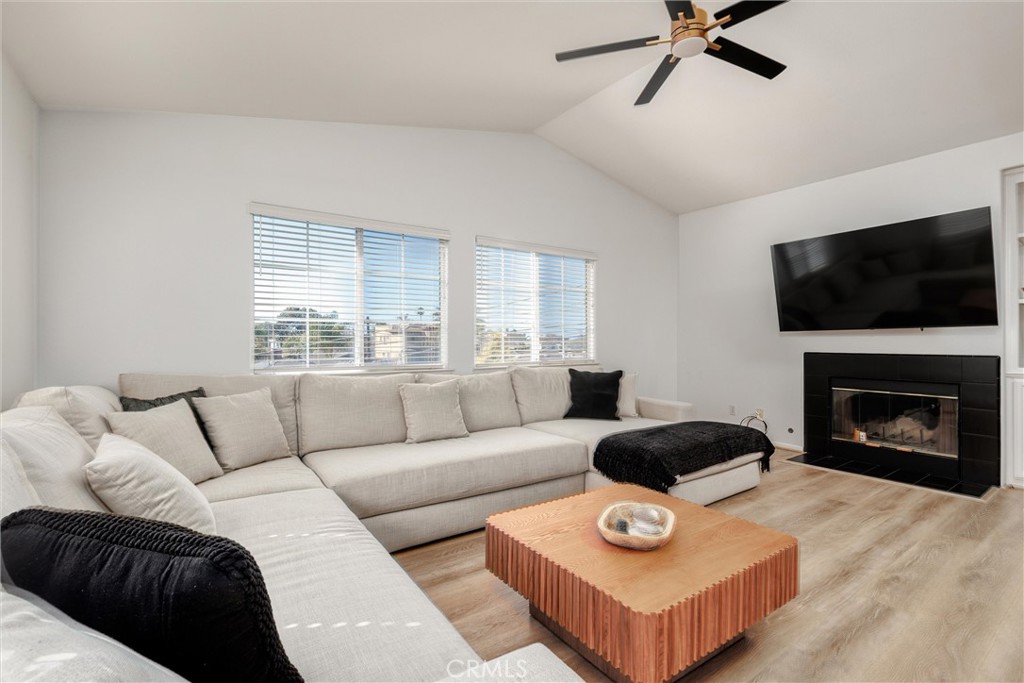 341 North 4th Street Grover Beach, CA 93433 - Photo 7 of 33 a living room with furniture a flat screen tv and a fireplace