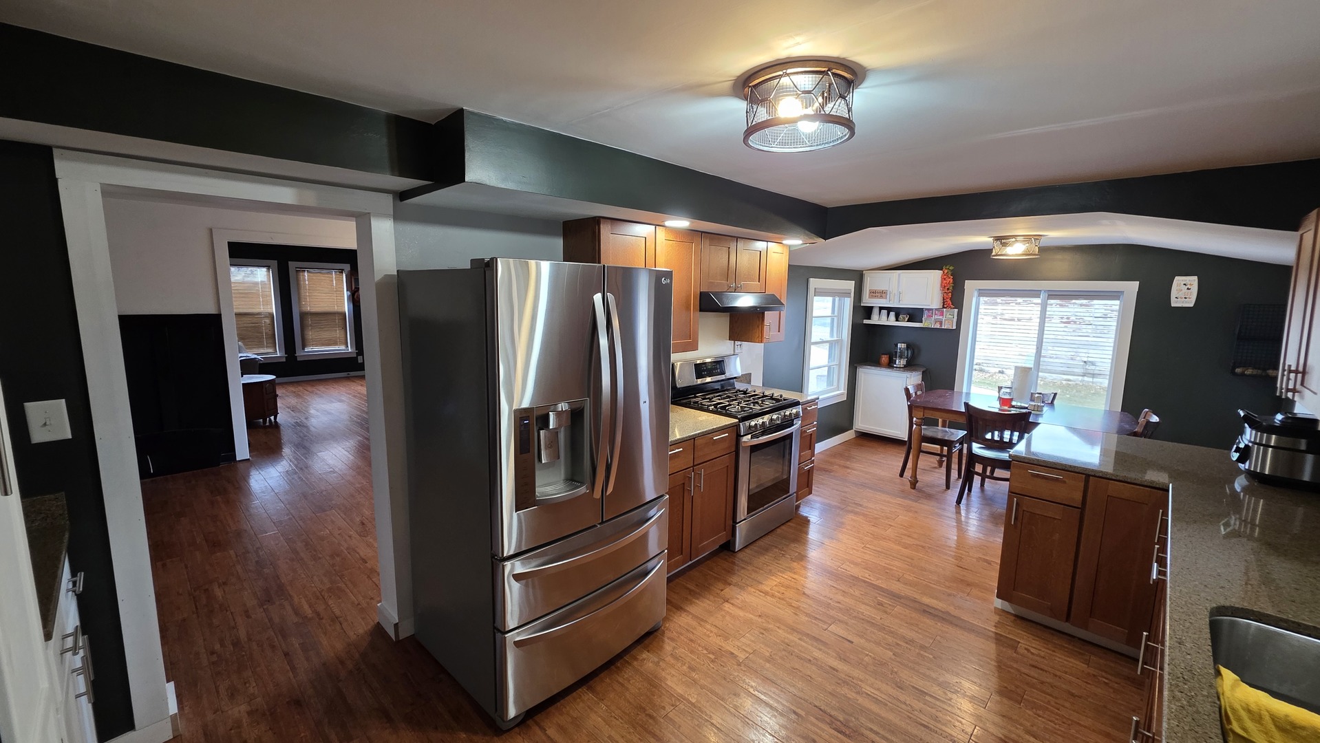 3494 Howlett Road Paw Paw, IL 61353 - Photo 2 of 21 a view of a dining room with furniture a chandelier and wooden floor