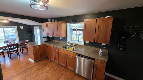 a kitchen with stainless steel appliances granite countertop sink stove top oven and cabinets