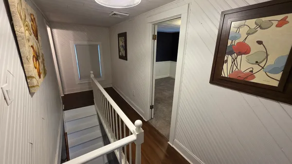 a view of an empty room with a ceiling fan