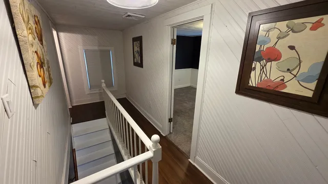 a view of an empty room with a ceiling fan