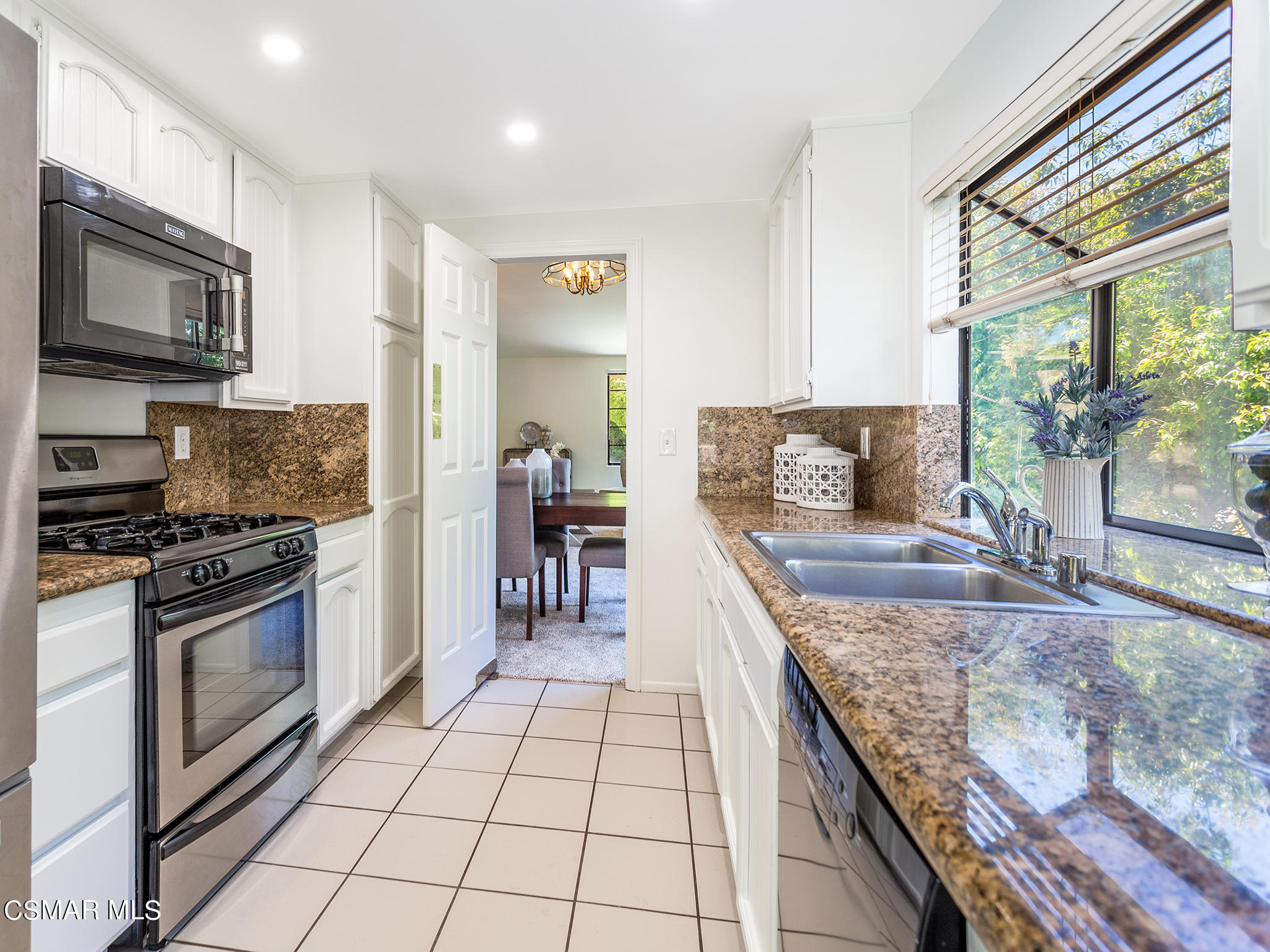 2978 Rikkard Drive Thousand Oaks, CA 91362 - Photo 6 of 21 a kitchen with stainless steel appliances granite countertop a stove top oven a sink a counter space and cabinets