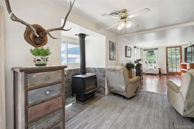 a living room with furniture a chandelier and a window
