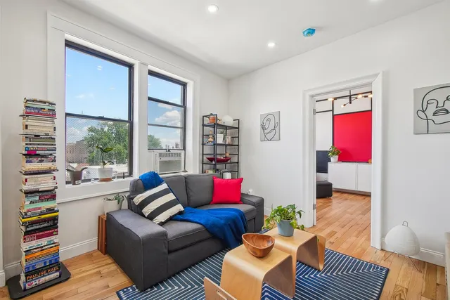 a living room with furniture and a large window