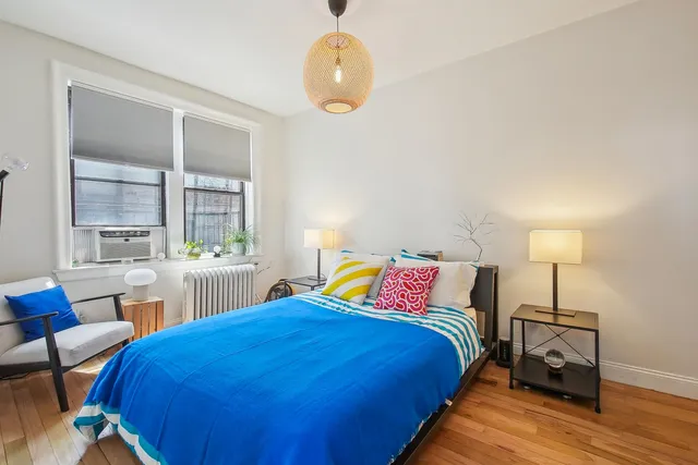 a bedroom with a bed and window