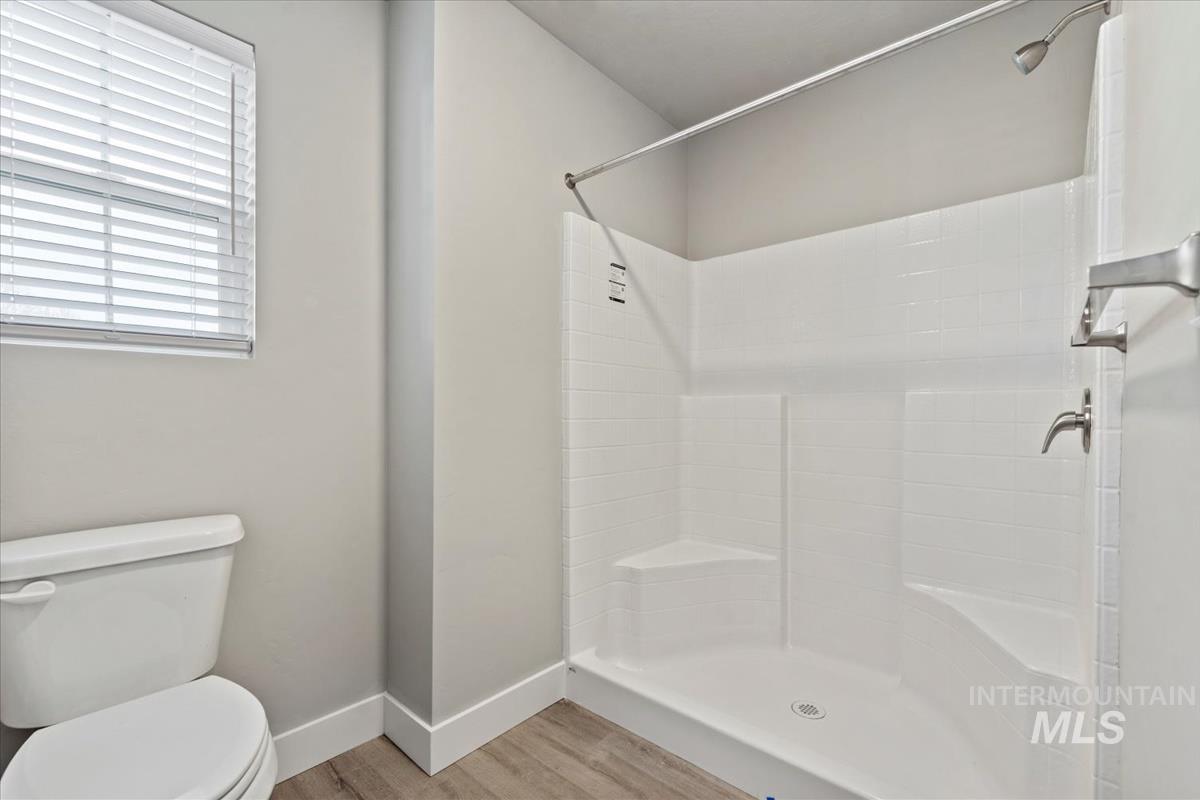 2791 West Palouse Street Boise, ID 83705 - Photo 12 of 26 Full bath featuring a shower stall and light wood-style floors