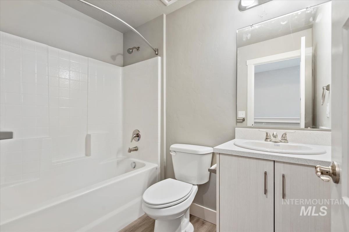 2791 West Palouse Street Boise, ID 83705 - Photo 17 of 26 Bathroom featuring bathtub / shower combination, vanity, and light wood finished floors