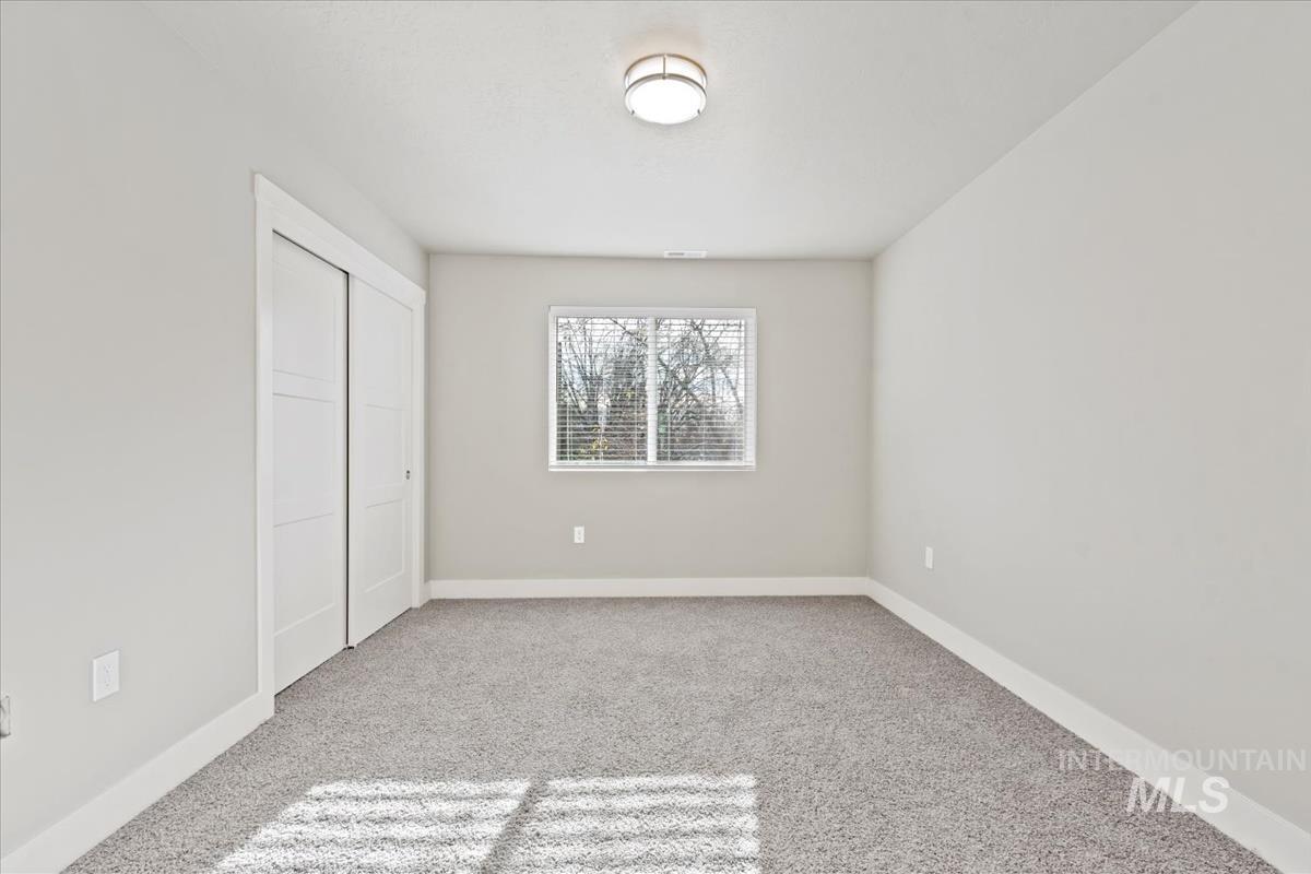 2791 West Palouse Street Boise, ID 83705 - Photo 18 of 26 Unfurnished bedroom with a closet and light colored carpet