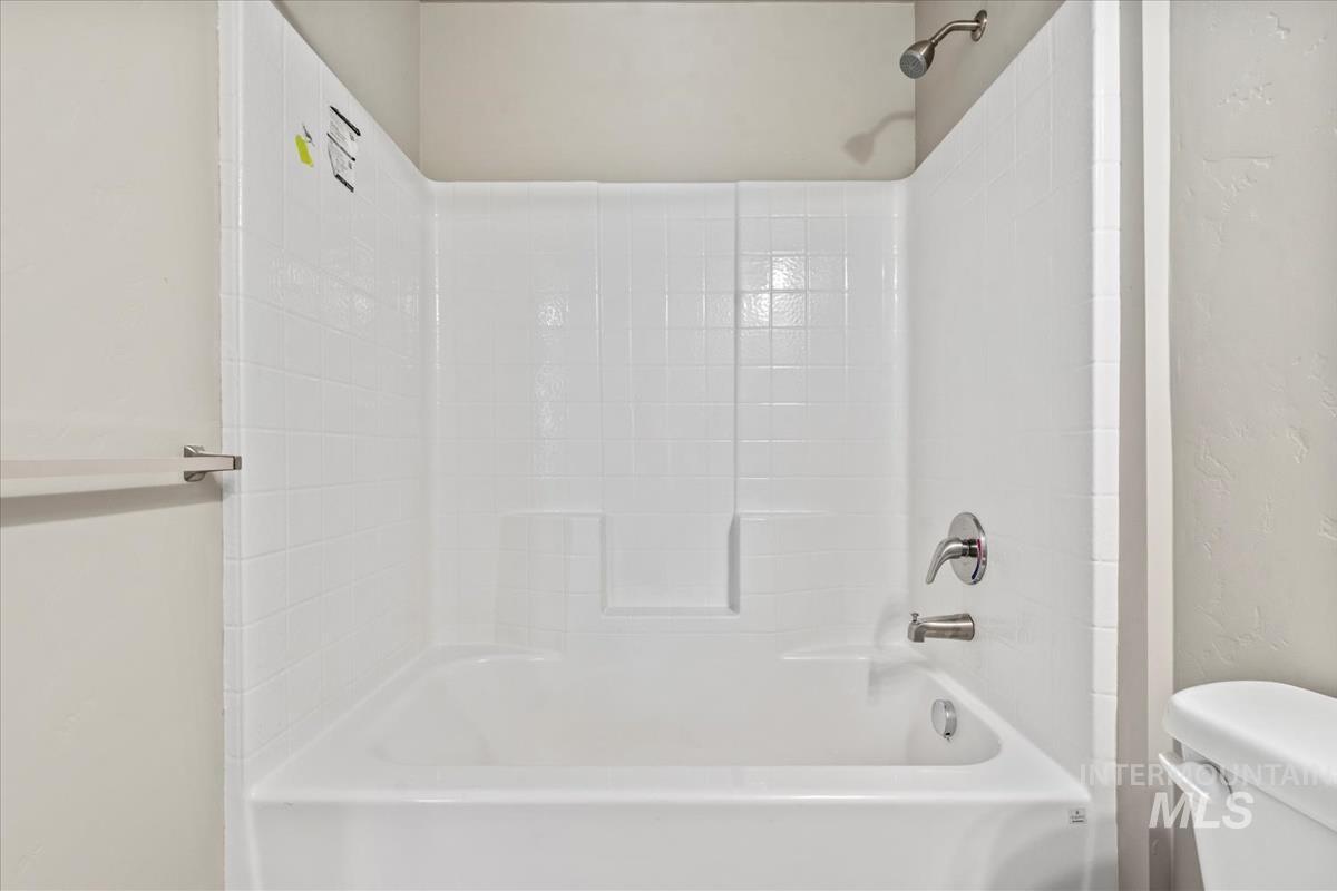 2791 West Palouse Street Boise, ID 83705 - Photo 20 of 26 Full bath with bathing tub / shower combination and a textured wall