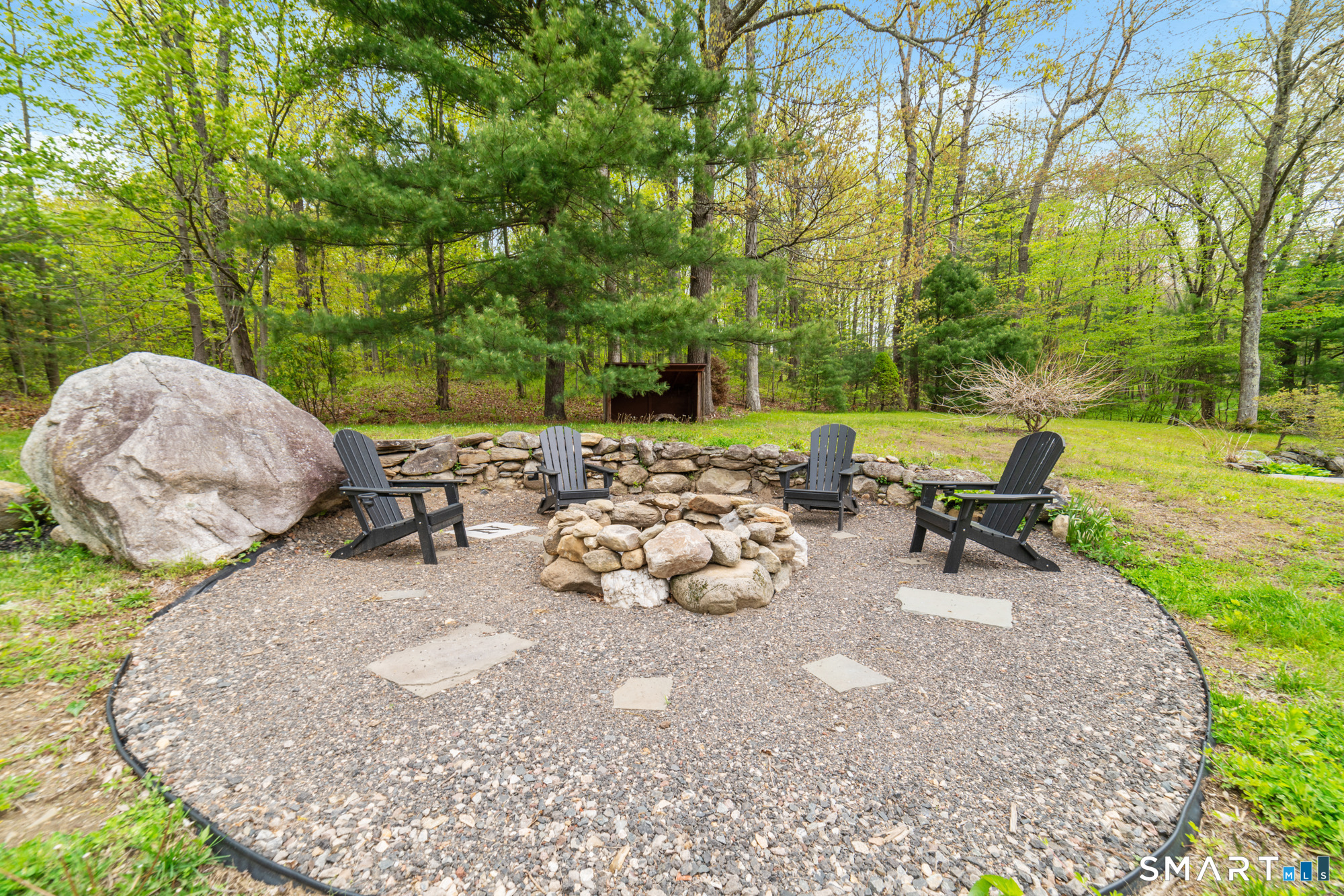 72 Wild Cat Hill Road Harwinton, CT 06791 - Photo 33 of 40 a view of a backyard with table and chairs couches and a fire pit