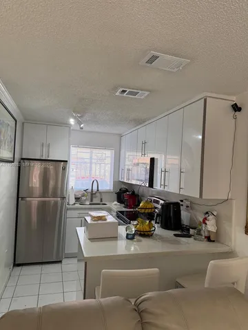 a kitchen with refrigerator and car