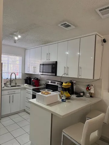 a kitchen with a sink cabinets and appliances