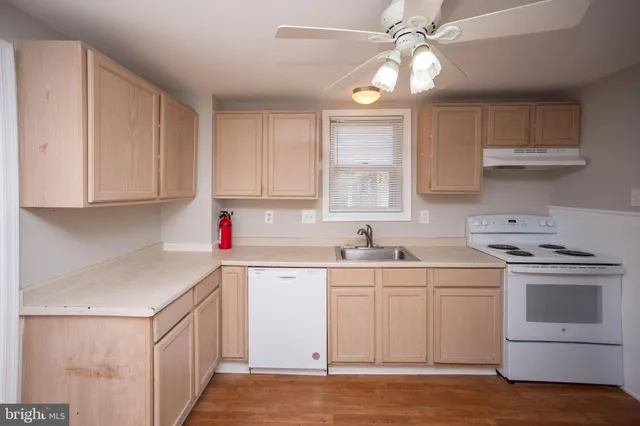 a kitchen with a sink cabinets and window