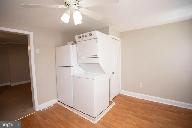 a kitchen with a refrigerator a sink dishwasher with a dining table and chairs