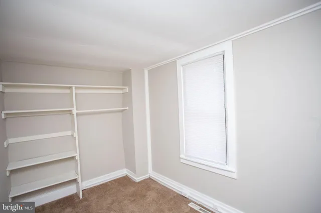 a view of an empty walk in closet
