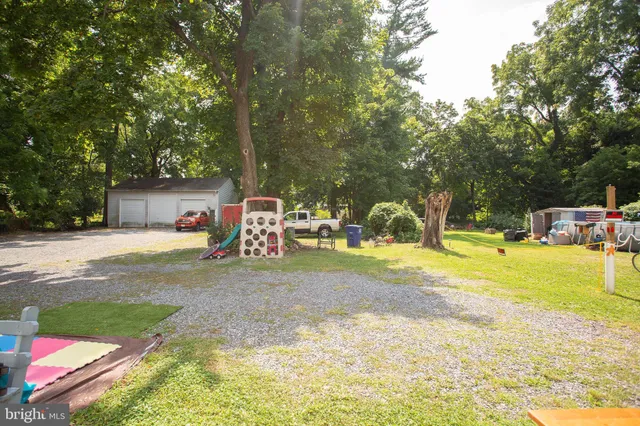 a view of a house with backyard and a slide