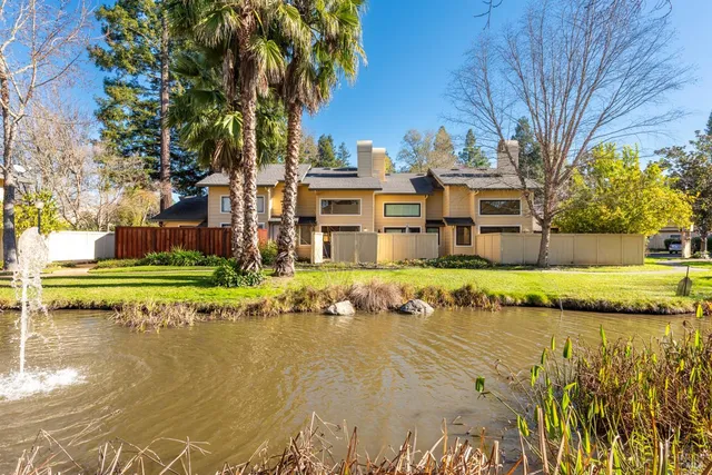 a front view of a house with a yard with swimming pool