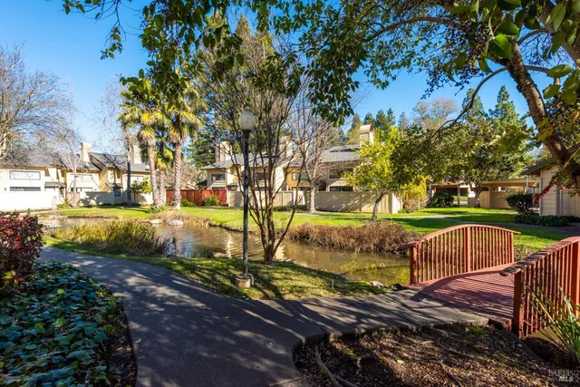 a view of a yard with wooden fence