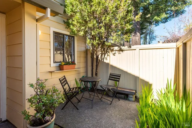 a view of a patio with table and chairs and potted plants