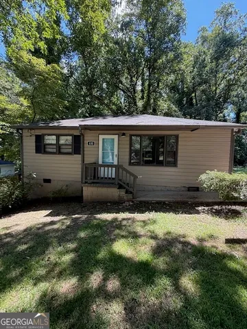 a view of house with backyard