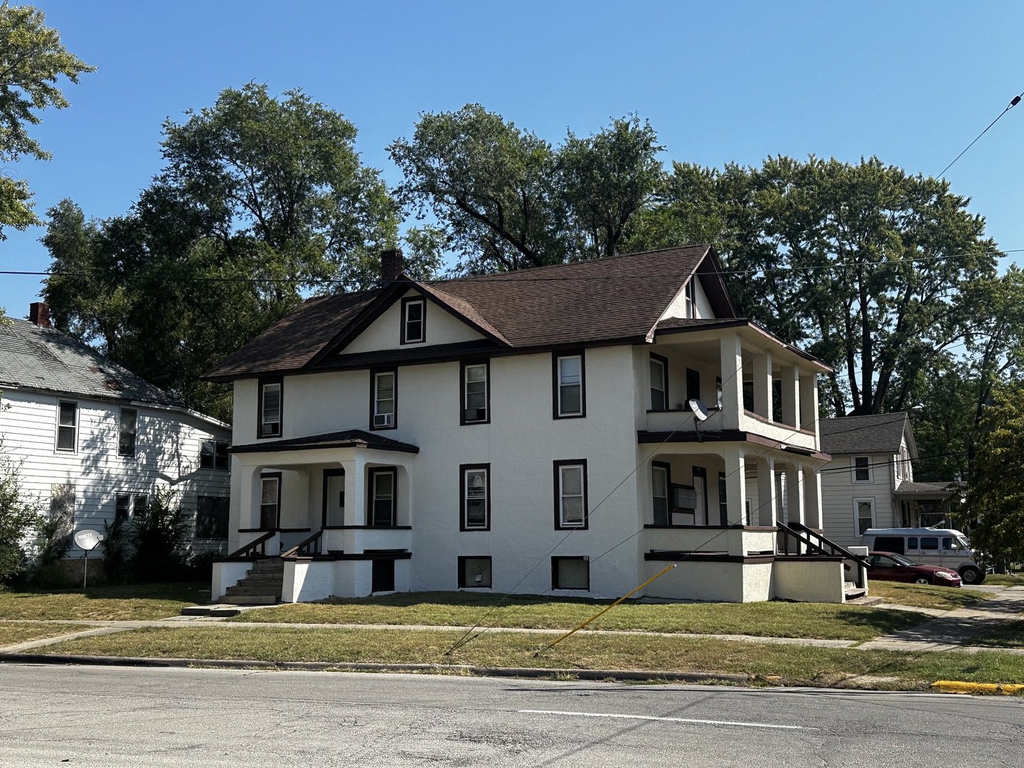 247 West Merchant Street Kankakee, IL 60901 - Photo 2 of 9 a front view of residential houses with yard and trees in the background