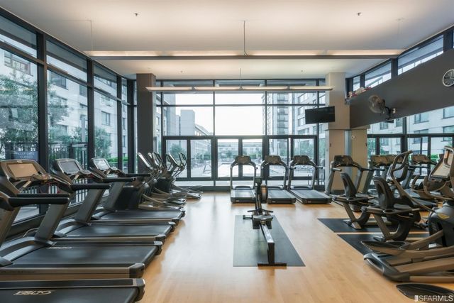 a view of a tall building next to a yard