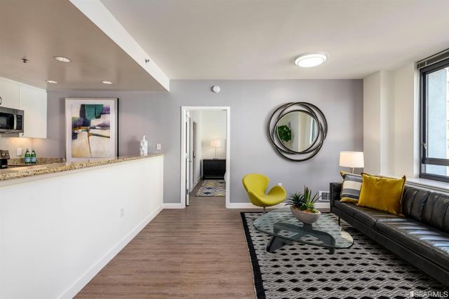 a kitchen with granite countertop a refrigerator and a sink