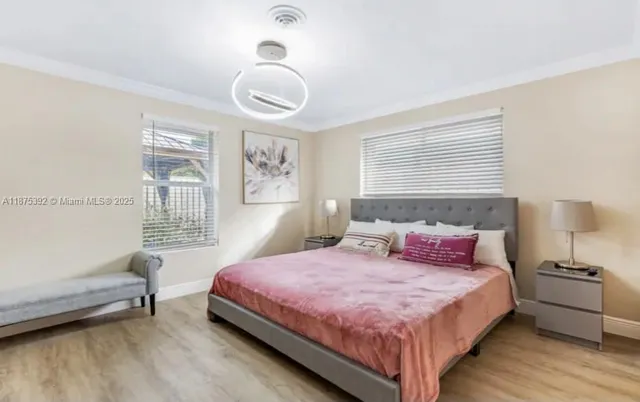 a bedroom with a bed and a large window