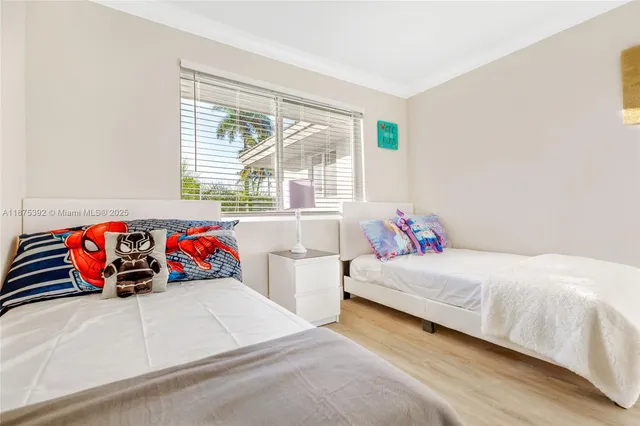 a view of a room with wooden floor and wall painting