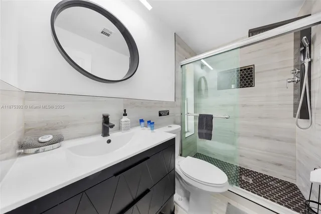 a front view of a house with a yard and potted plants