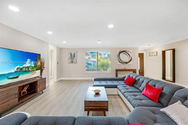 a living room with furniture and a flat screen tv