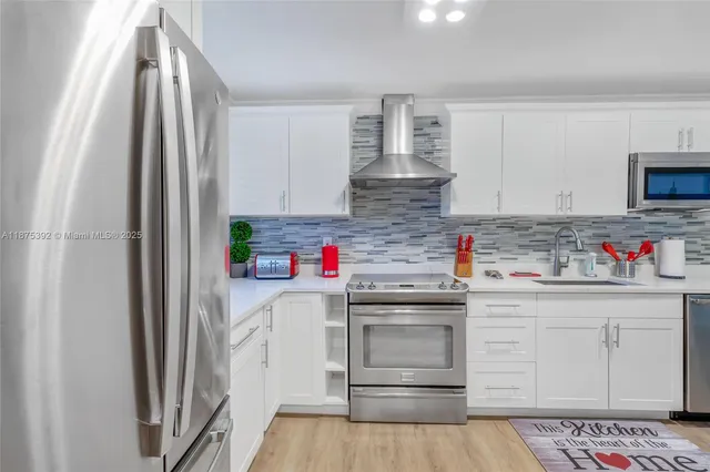 a kitchen with stainless steel appliances granite countertop a refrigerator and sink