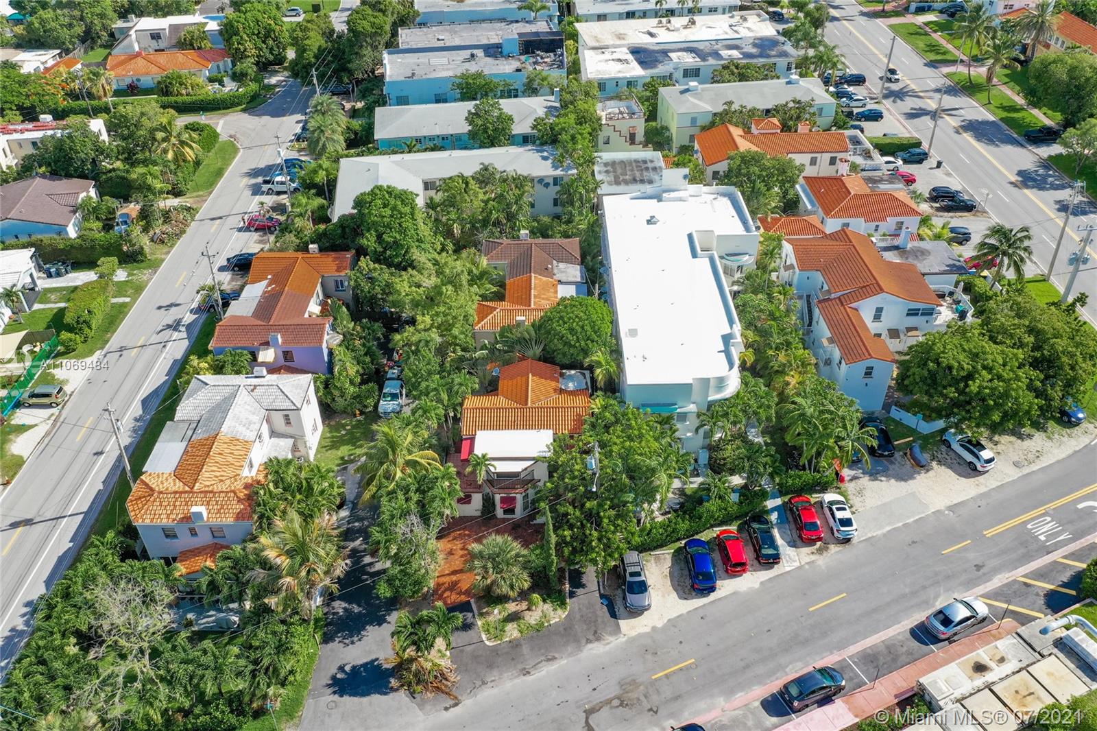 an aerial view of residential houses with outdoor space and street view