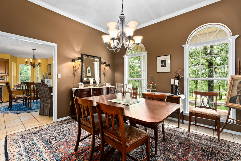 365 Calihan Road Booneville, AR 72927 - Photo 28 of 59 Dining room featuring an arched window, white trim, crown molding, and a chandelier