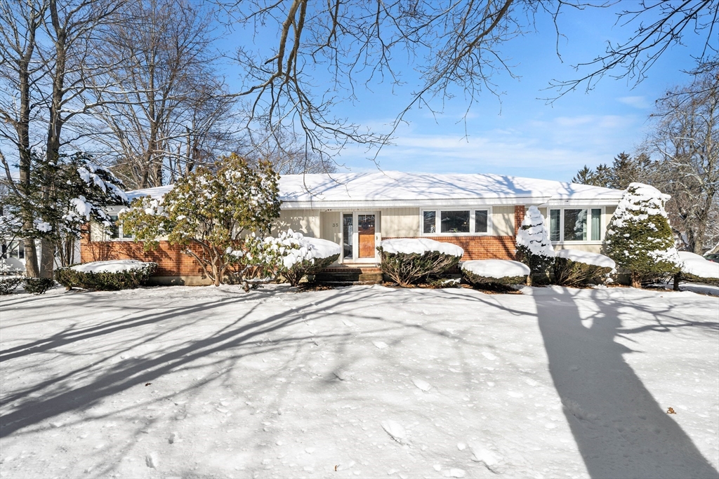 a view of a house with a yard covered in snow