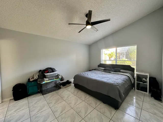 a bedroom with a bed and a ceiling fan