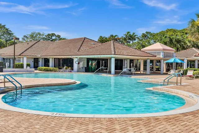a view of a house with swimming pool and a yard