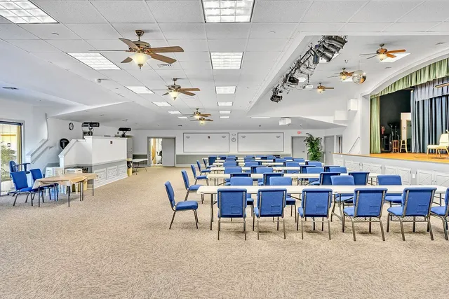 a view of a house with potted plants and a table