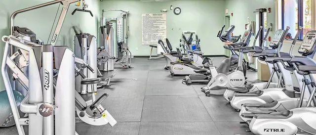 a view of a patio with a table and chairs under an umbrella