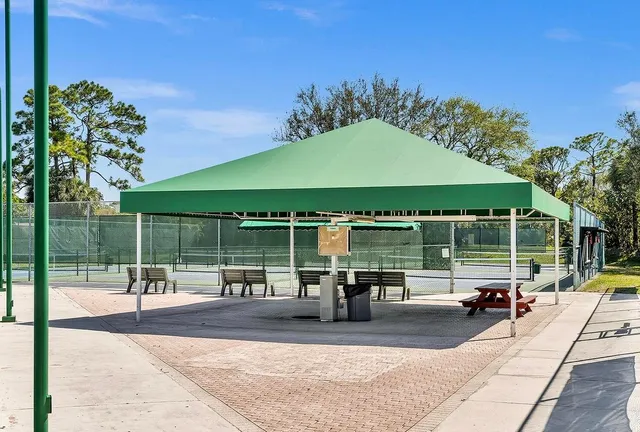a view of a house with a yard and potted plants