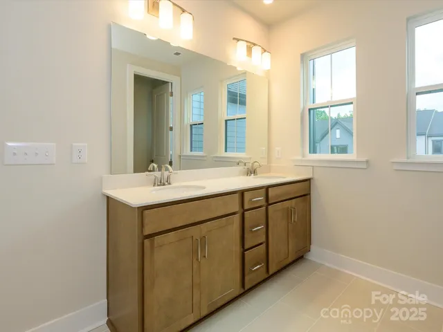 a bathroom with 2 sink and a mirror