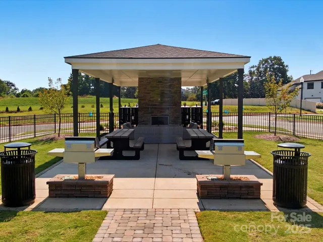 a living room with patio furniture and a fireplace