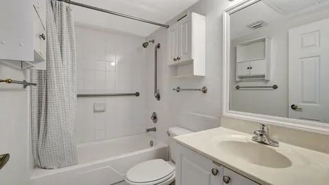a bathroom with a sink toilet tub and shower