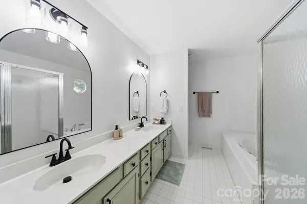 a spacious bathroom with a double vanity sink mirror and double