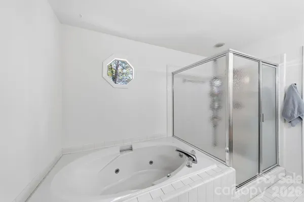 a bathroom with a bathtub and a shower