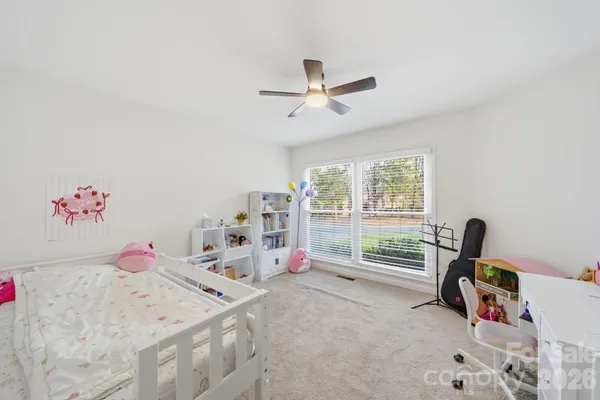 a bedroom with furniture and baby bed