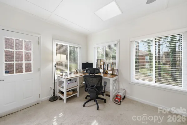 a room with table chairs and windows