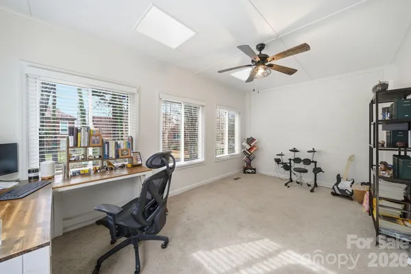 a living room with furniture a window and a chandelier