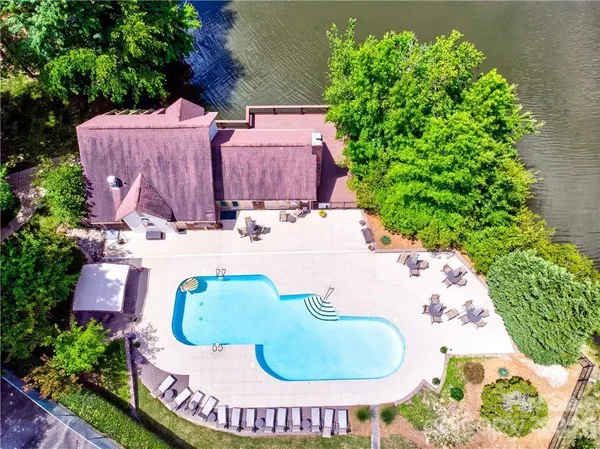 a view of a house with swimming pool and a yard